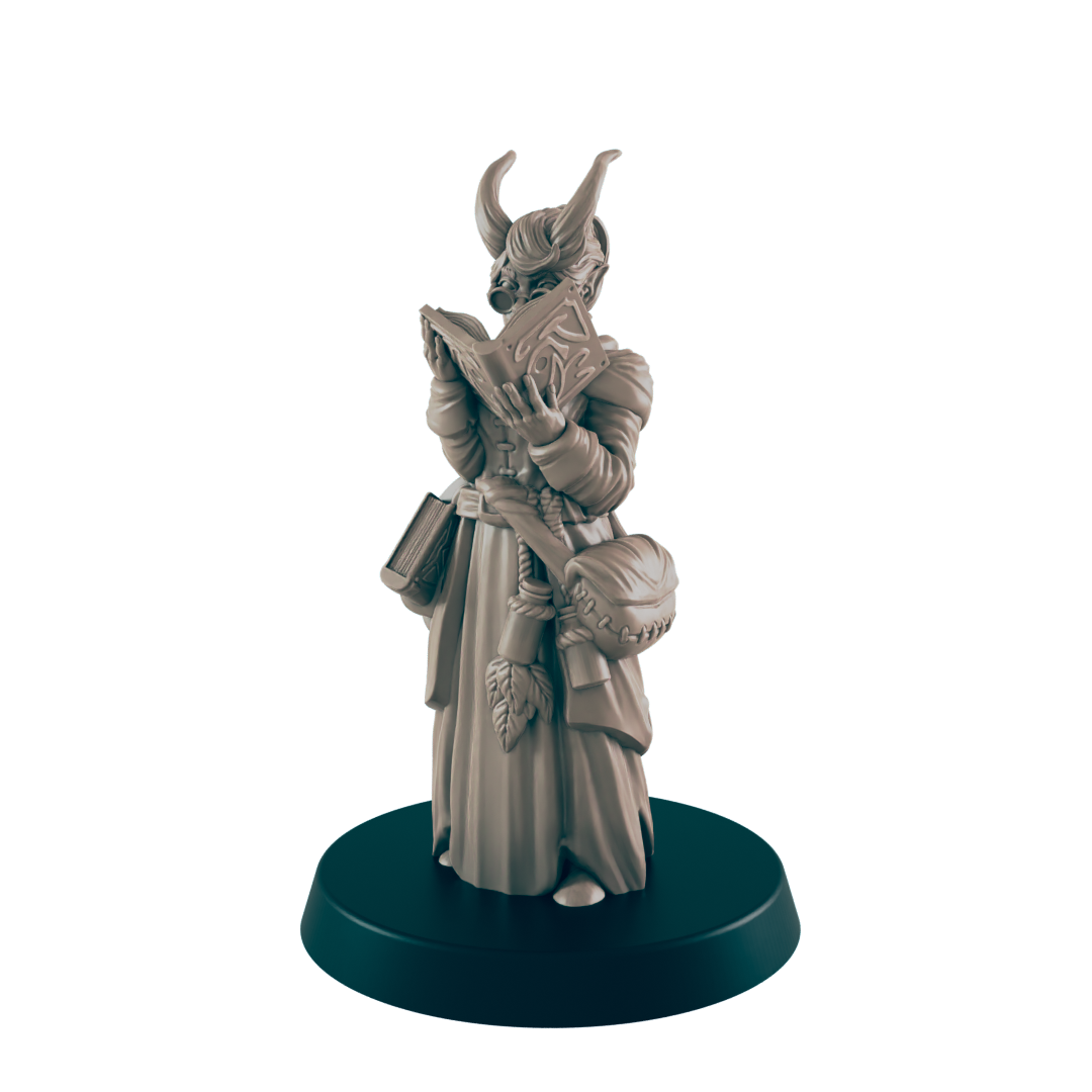 The horned tiefling miniature stands on a dark blue base, reading a book. She wears a robe, satchel, and belt with leaves, with the dark background.