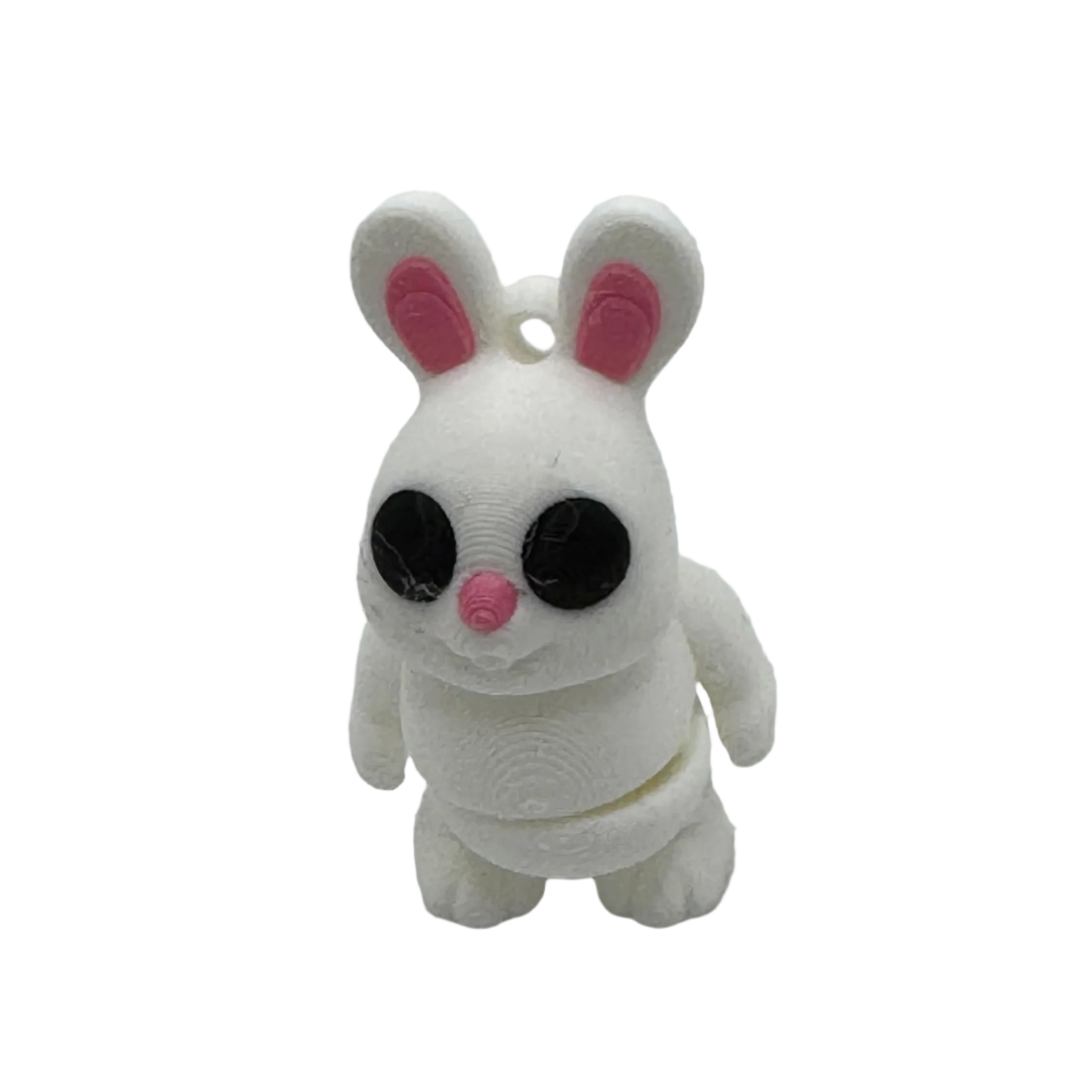 A white 3D-printed rabbit figurine stands on a black surface. The bunny has pink inner ears and a pink nose with large black eyes.