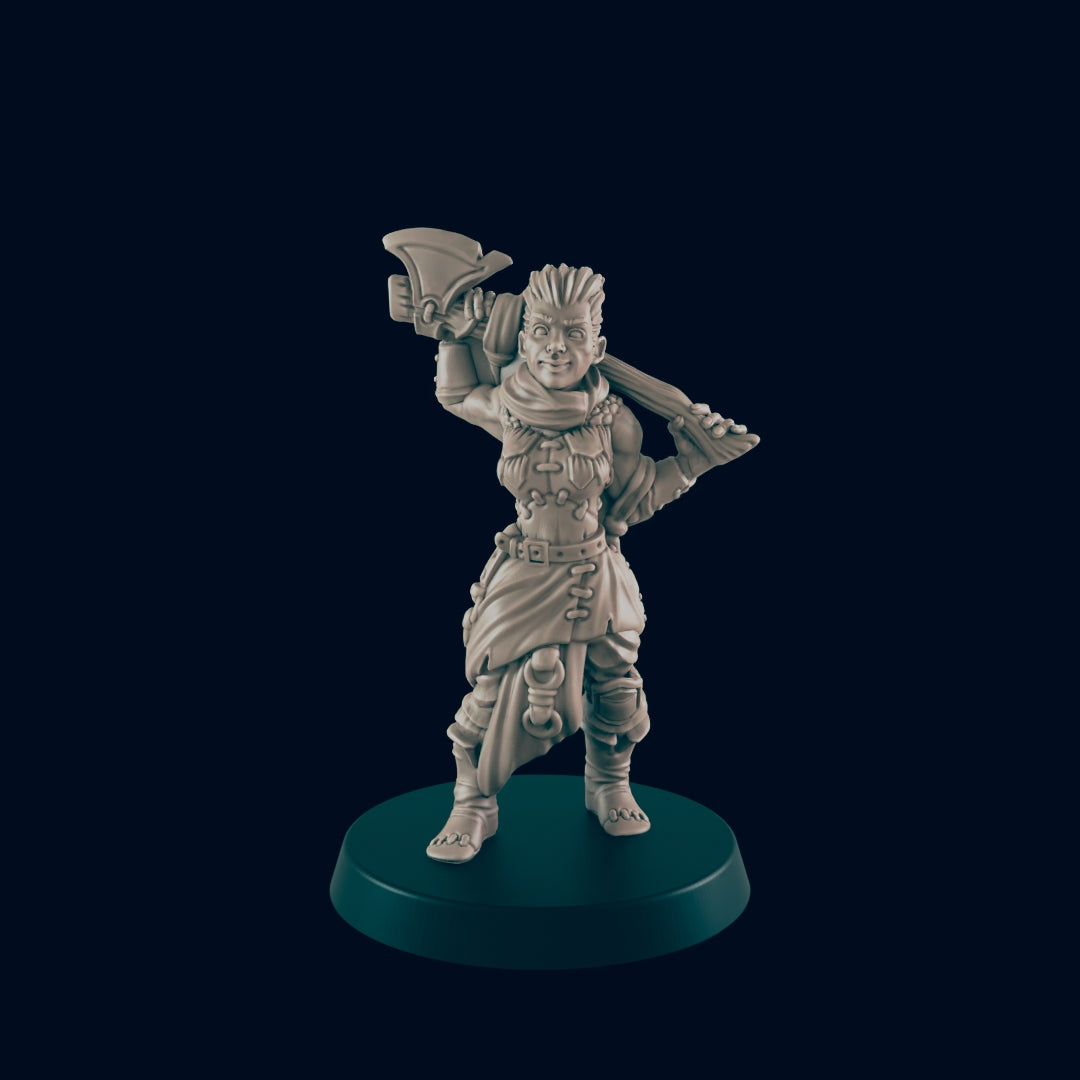 A miniature warrior stands on a dark green base, carrying a large axe over her shoulder. Her clothing appears functional, and she looks ready for a fight.
