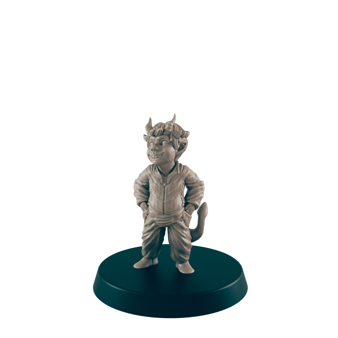 A small, smiling imp figurine stands on a round base against a dark background. The figurine is sculpted in a relaxed pose, hands in pockets.
