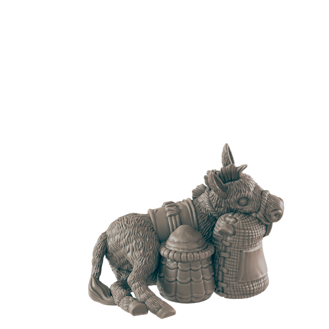 A donkey figurine rests against two sacks; one woven, one barrel-shaped, against a dark background.