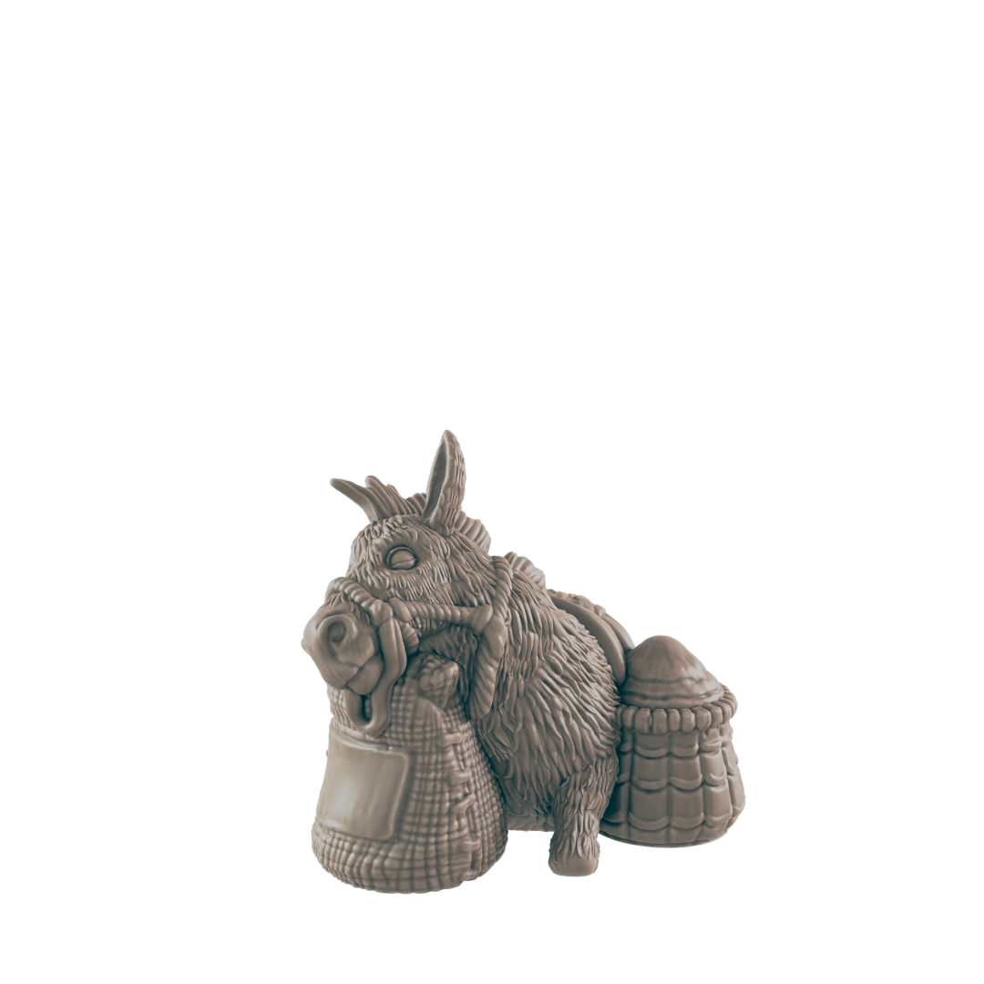 A donkey figurine carries sacks and a basket; it rests against a plain dark background.