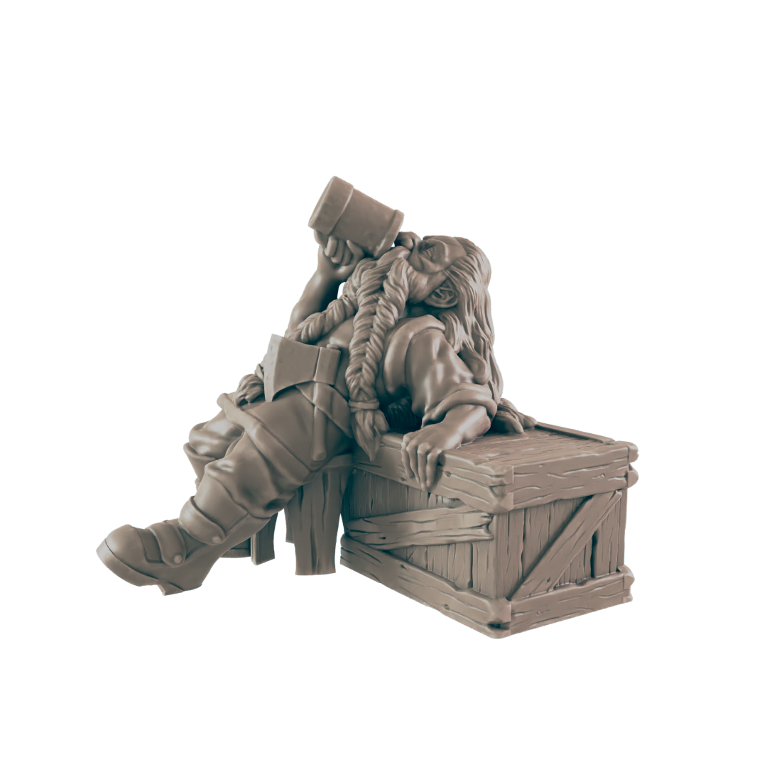 A monochrome dwarf figurine is slumped over a wooden crate, drinking from a tankard. Her braids are long and thick, and she is wearing boots, a tunic, and an axe across her chest.