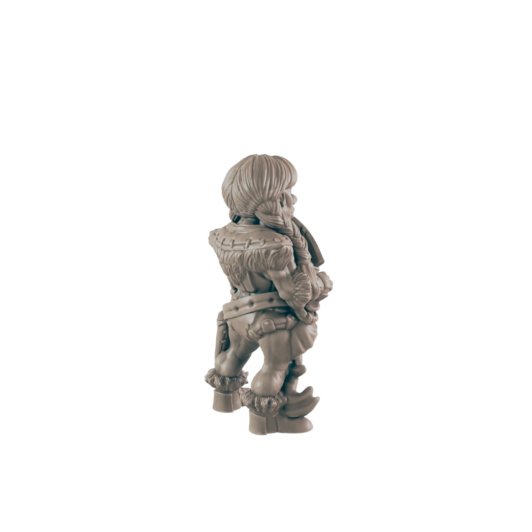 A small, fur-clad figurine stands, facing away, against a black background. It appears to be a miniature of a humanoid creature with short hair and sturdy boots.