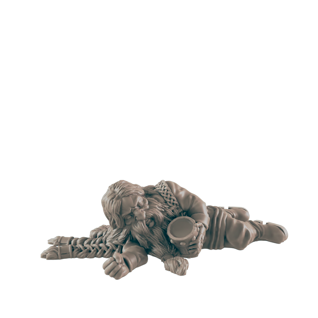 A dwarf miniature lies asleep, clutching a mug; the figure is on a plain background.