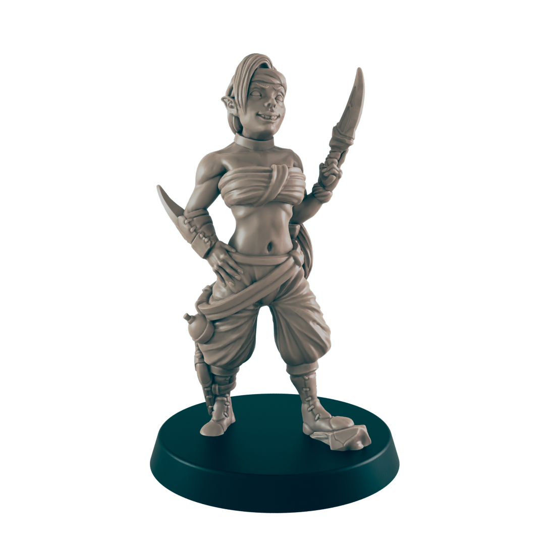 A female miniature figure, wielding a dagger, stands confidently on a dark circular base. She is depicted in a fantasy setting, wearing loose-fitting clothing.