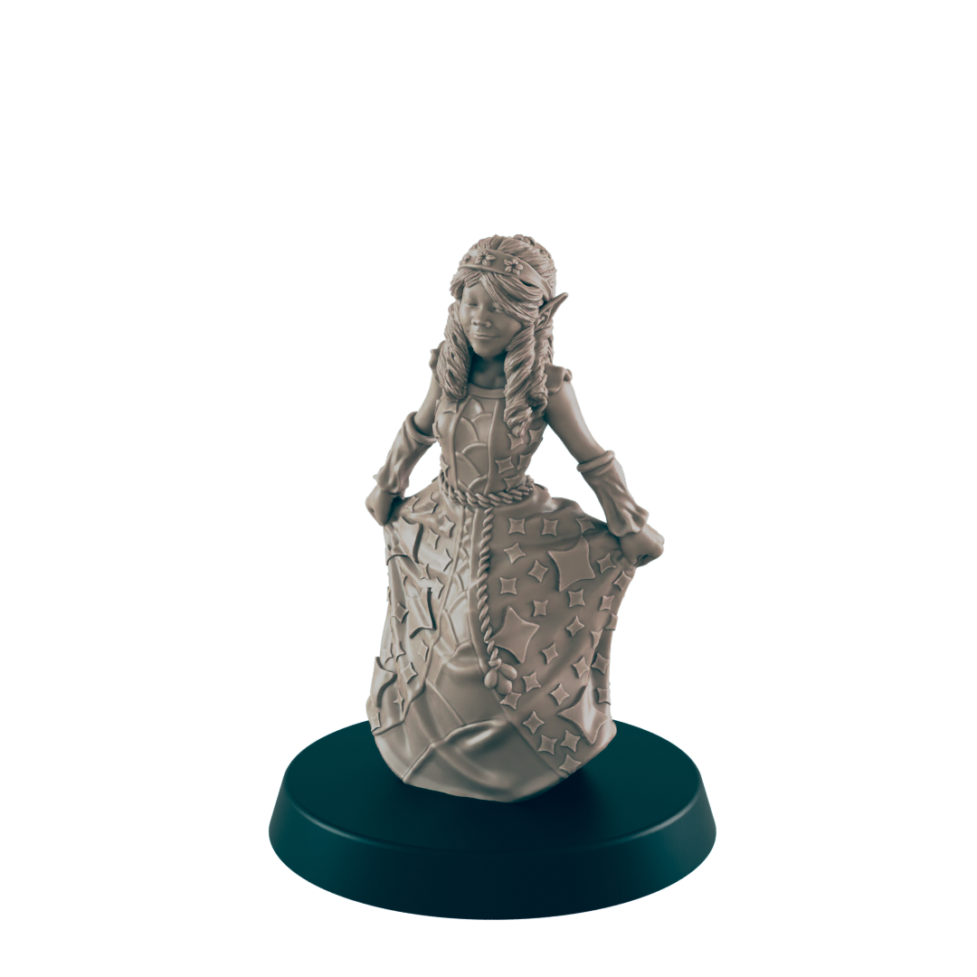 A miniature elf girl in a star-covered dress poses on a dark green base. The figure is unpainted and gray against a solid black background.