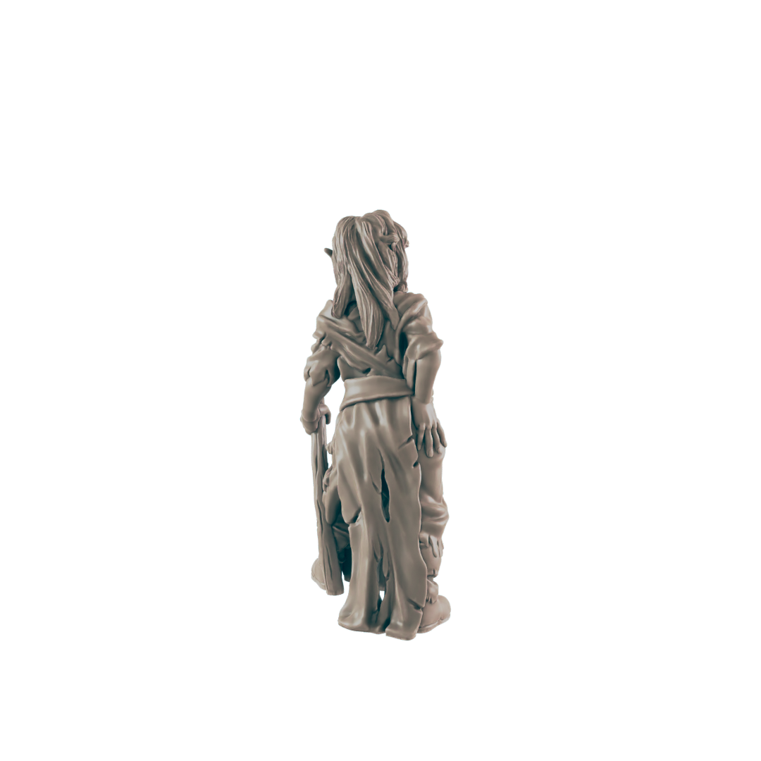 A miniature goblin figurine stands against a dark background; it holds a club and faces away.