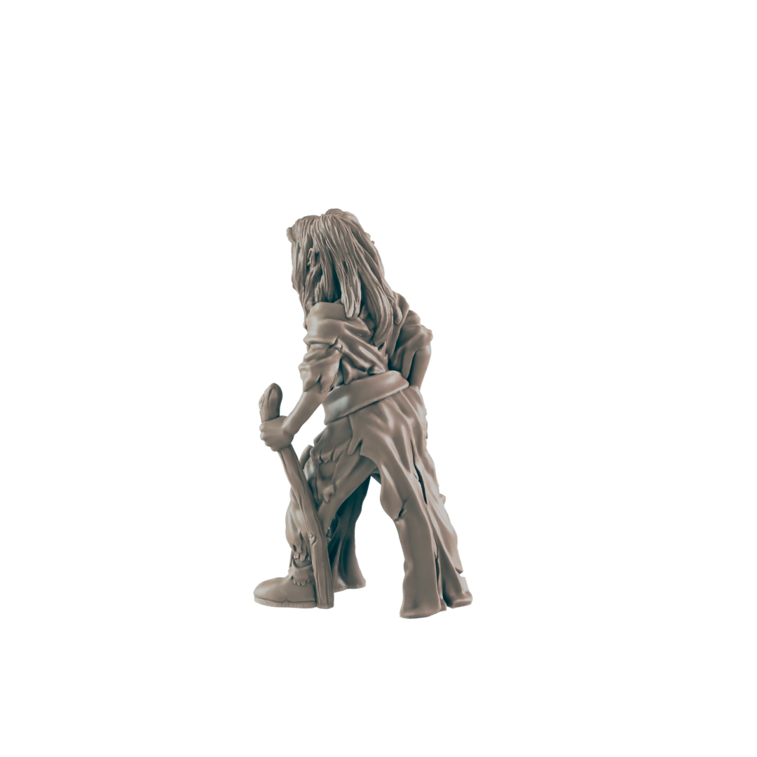 A miniature figurine of a hunched, long-haired figure holds a staff, appearing to stand against a dark background.