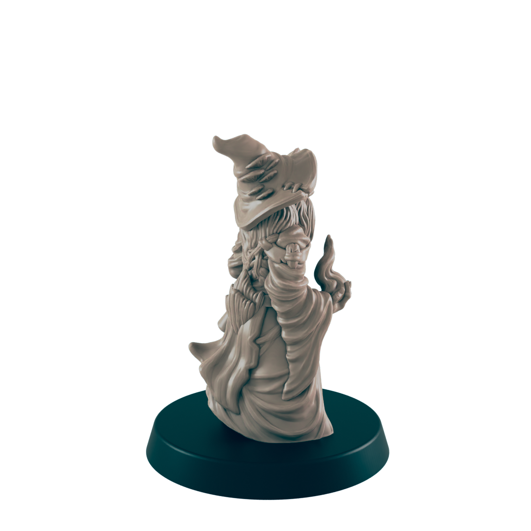 A miniature wizard figurine stands on a dark circular base. The figure is sculpted in a robe and pointed hat, appearing to cast a spell.