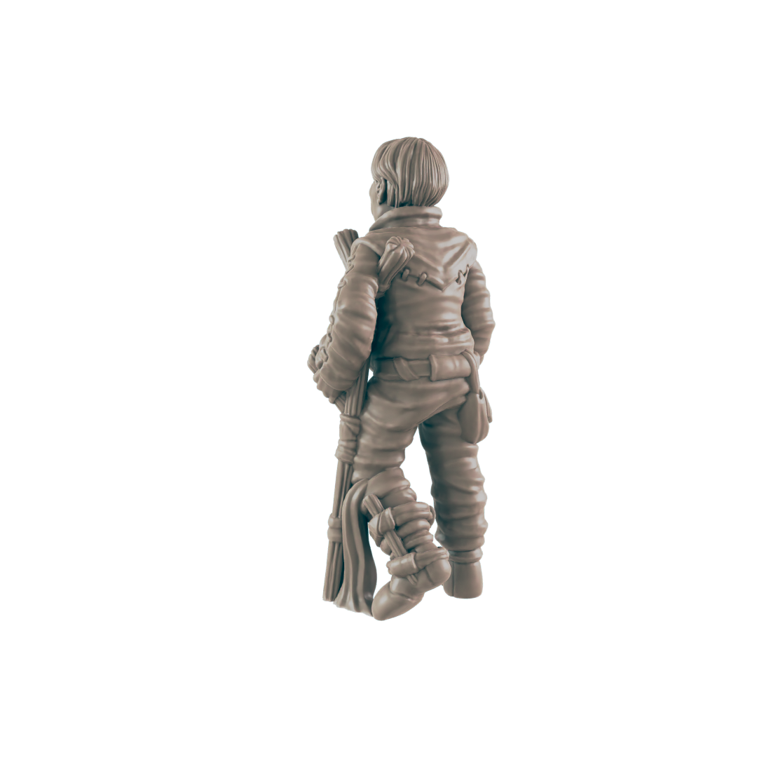 A miniature figurine of a person stands, holding a staff, against a dark background.