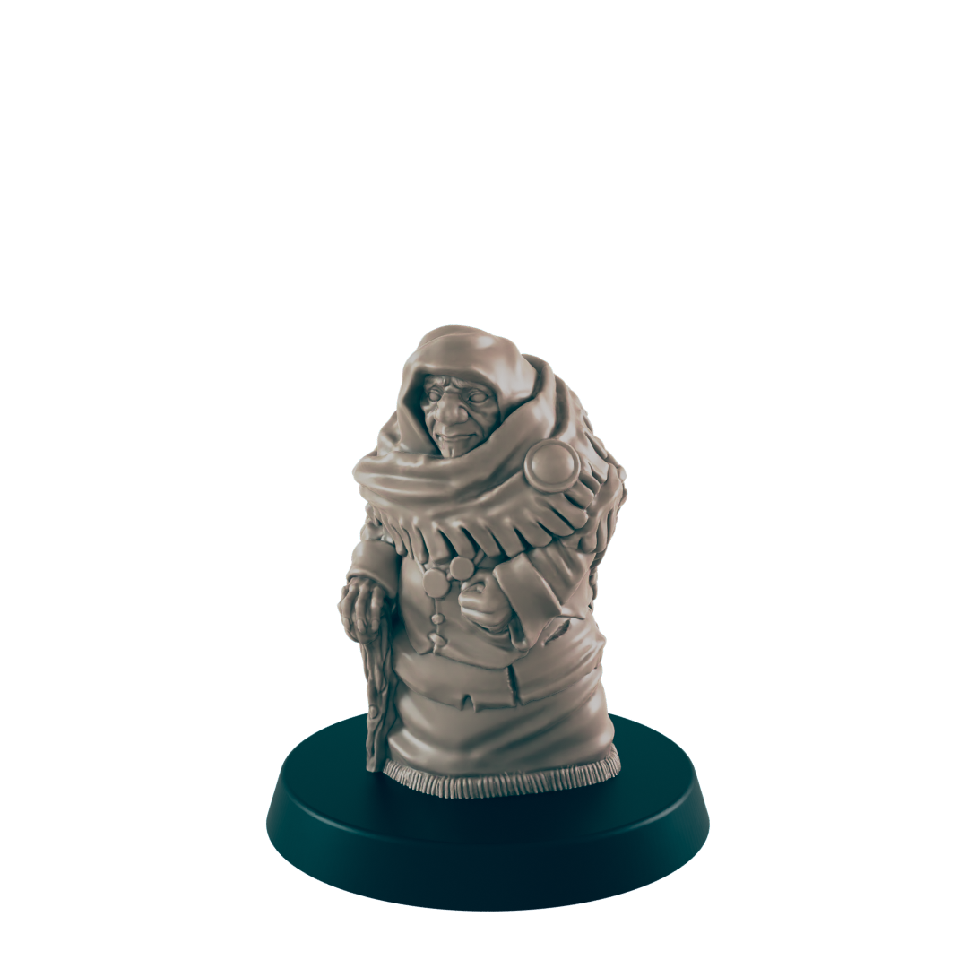 A miniature figurine of an elderly person, wearing a hooded cloak and holding a staff, stands on a dark circular base.