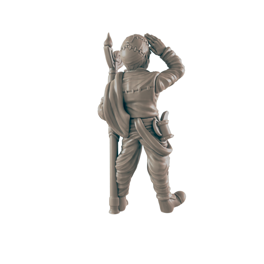 A miniature figurine of a person, possibly a soldier, stands holding a long staff, shielding their eyes against the sun. The context is unknown, but the figurine is seemingly isolated.