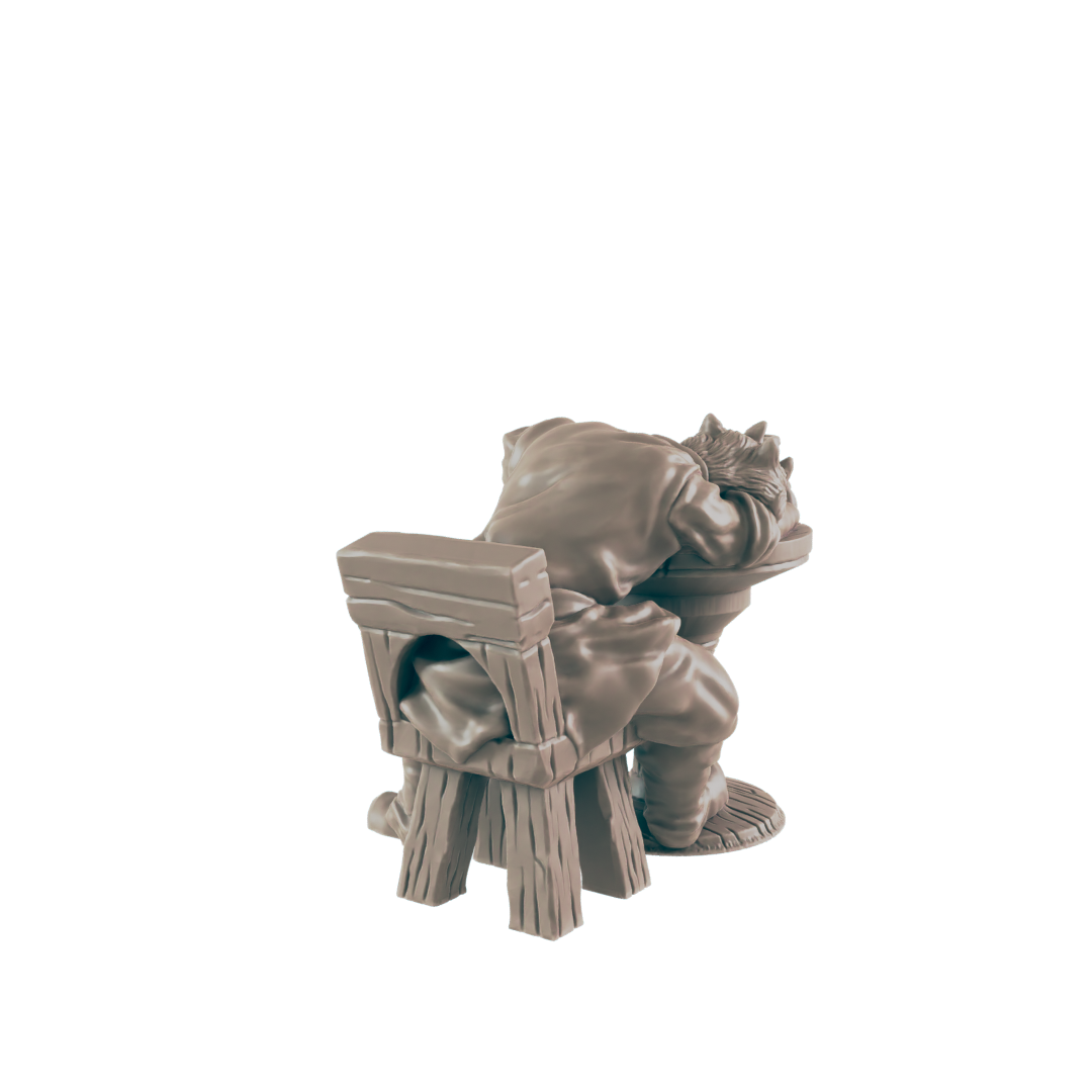 A miniature figurine of a person slouched over a simple wooden chair, appearing to be asleep or resting; the scene is isolated against a black background.
