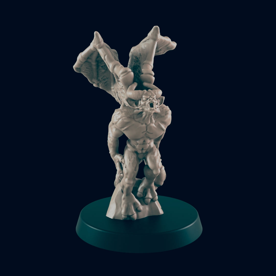 A winged demon figurine stands on a base. The demon has horns, a fierce expression, and large wings outstretched. It is set against a dark background.