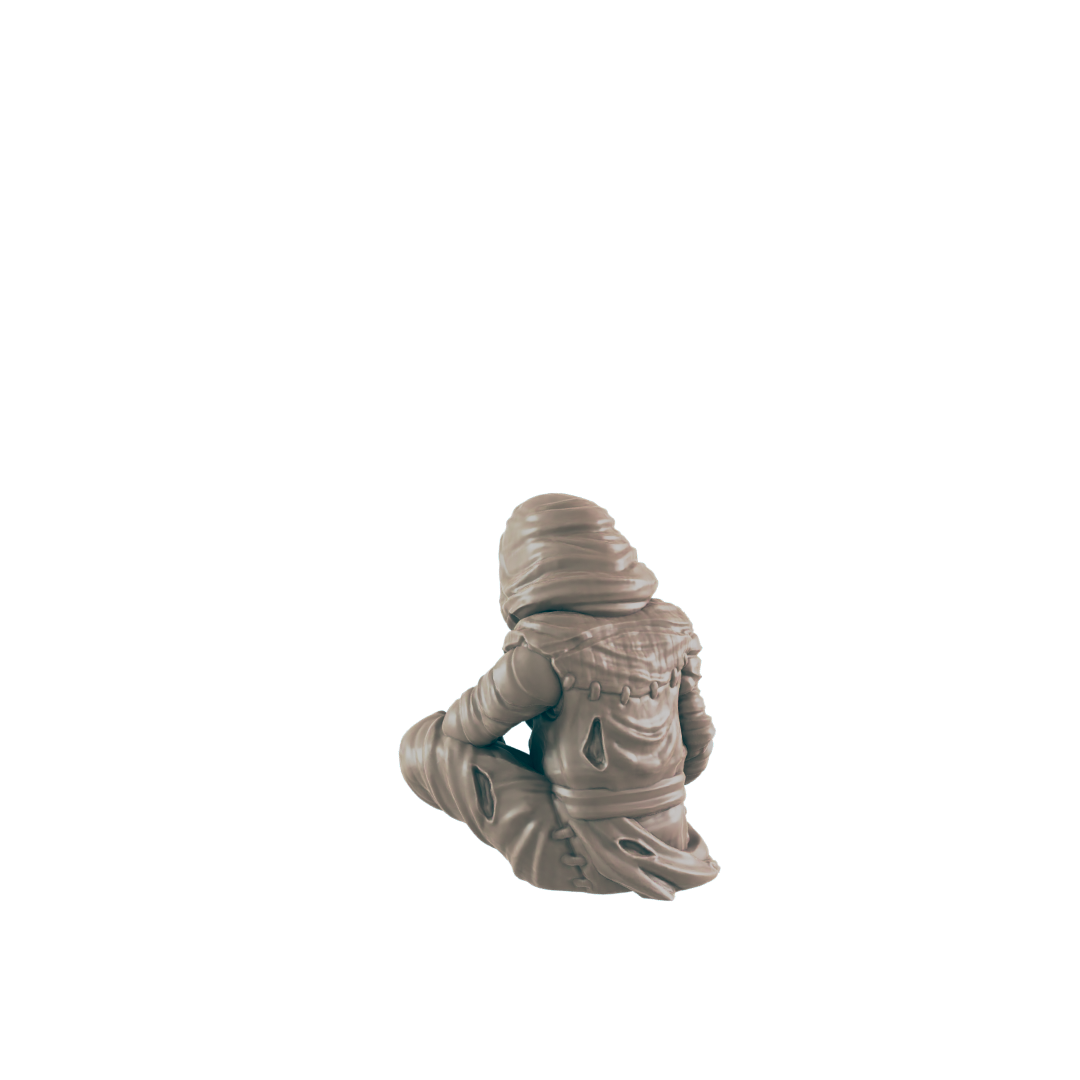 A small, hooded figure sits cross-legged against a black background. The figure is light beige, appearing to be sculpted.
