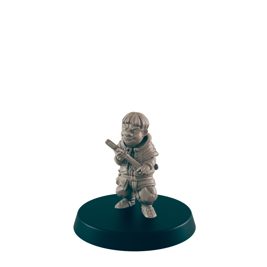 A small, grey figurine of a gnome-like character holds a staff, standing on a dark circular base.