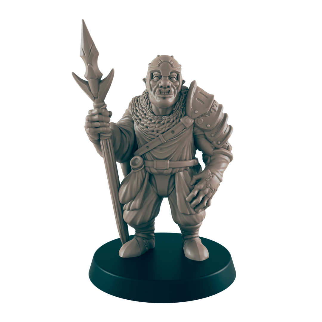 A miniature orc figure stands holding a spear. He wears armor and a cloak. The figure is displayed on a dark circular base.