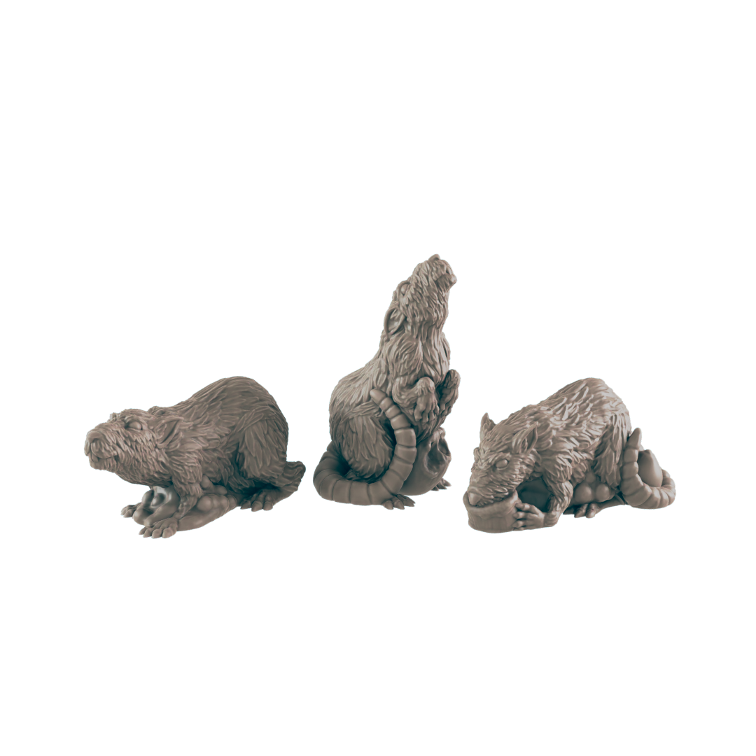 Three rat-like figurines are posed; one is crouched, one sits upright, and one lies down. They are arranged in a row against a black background.