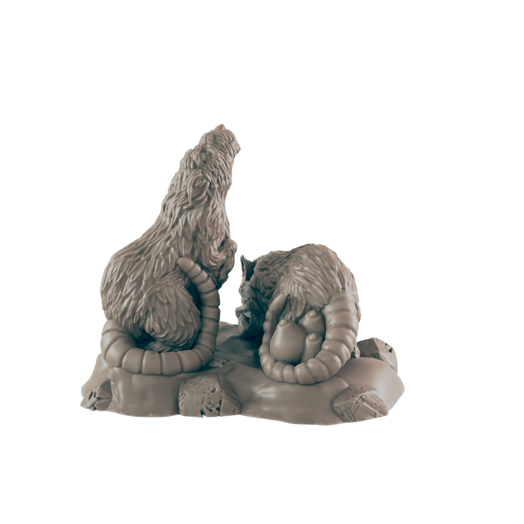 Two rat-like figures, sculpted in a seated position on a rocky base, interact. One appears to be observing the other, which holds a small, round object.