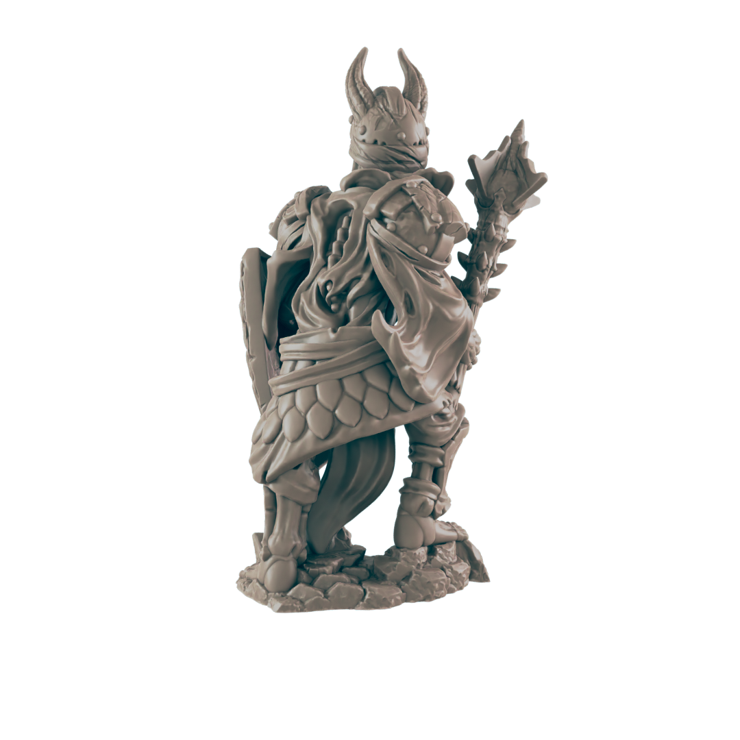 A miniature figurine of a horned, armored figure stands on a rocky base, holding a shield and staff; it is viewed from behind against a dark background.