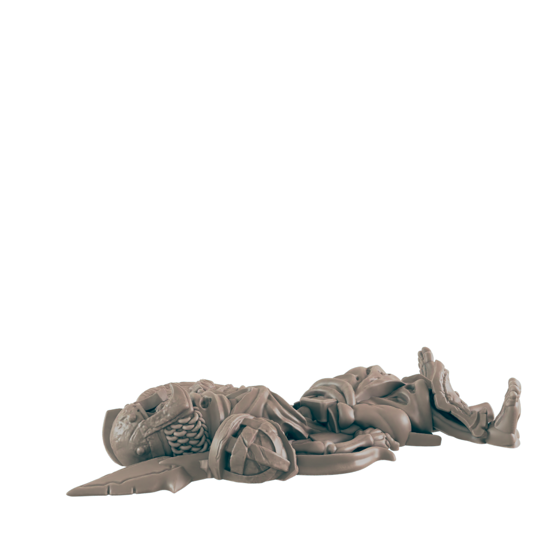 A miniature figure lies broken on a dark background. It appears to be a warrior, possibly from a game, in a defeated pose.