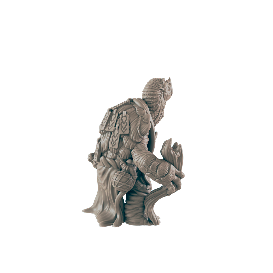 A miniature figurine of a tree-like creature, holding a staff, sits against a dark background.