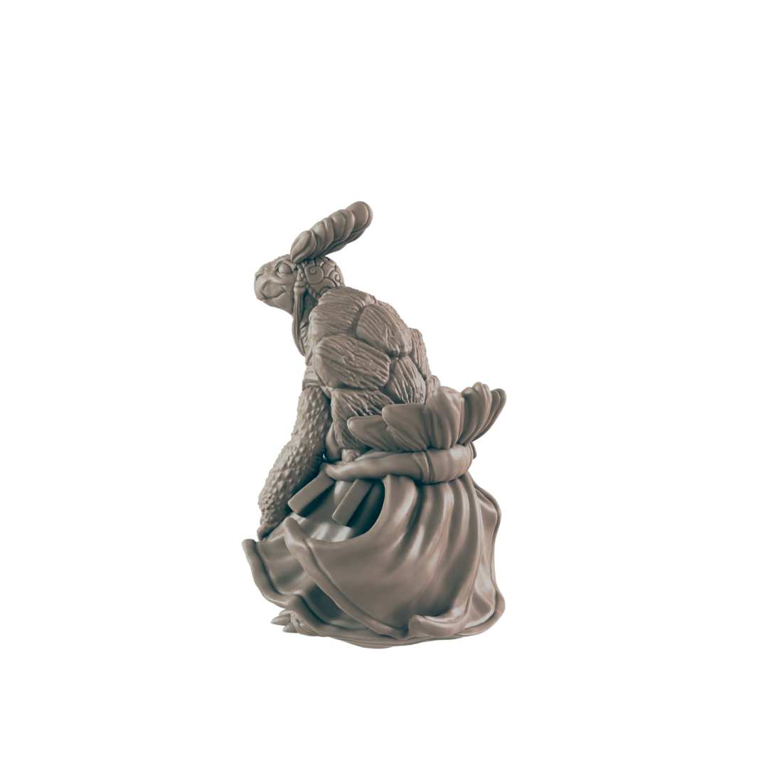 A turtle figurine, wearing a flowing dress and bunny ears, sits against a dark background.