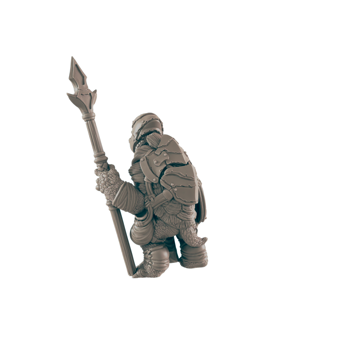 A turtle-like miniature figure, clad in armor, stands holding a spear; it's positioned against a dark background.