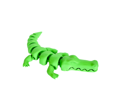 A segmented, neon-green plastic alligator crawls in a black void.