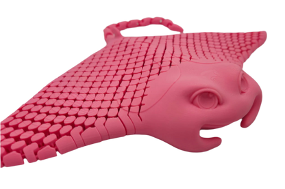 A pink, 3D-printed manta ray sits facing slightly right. Its dorsal surface has a tessellated pattern, and it floats against a black background.