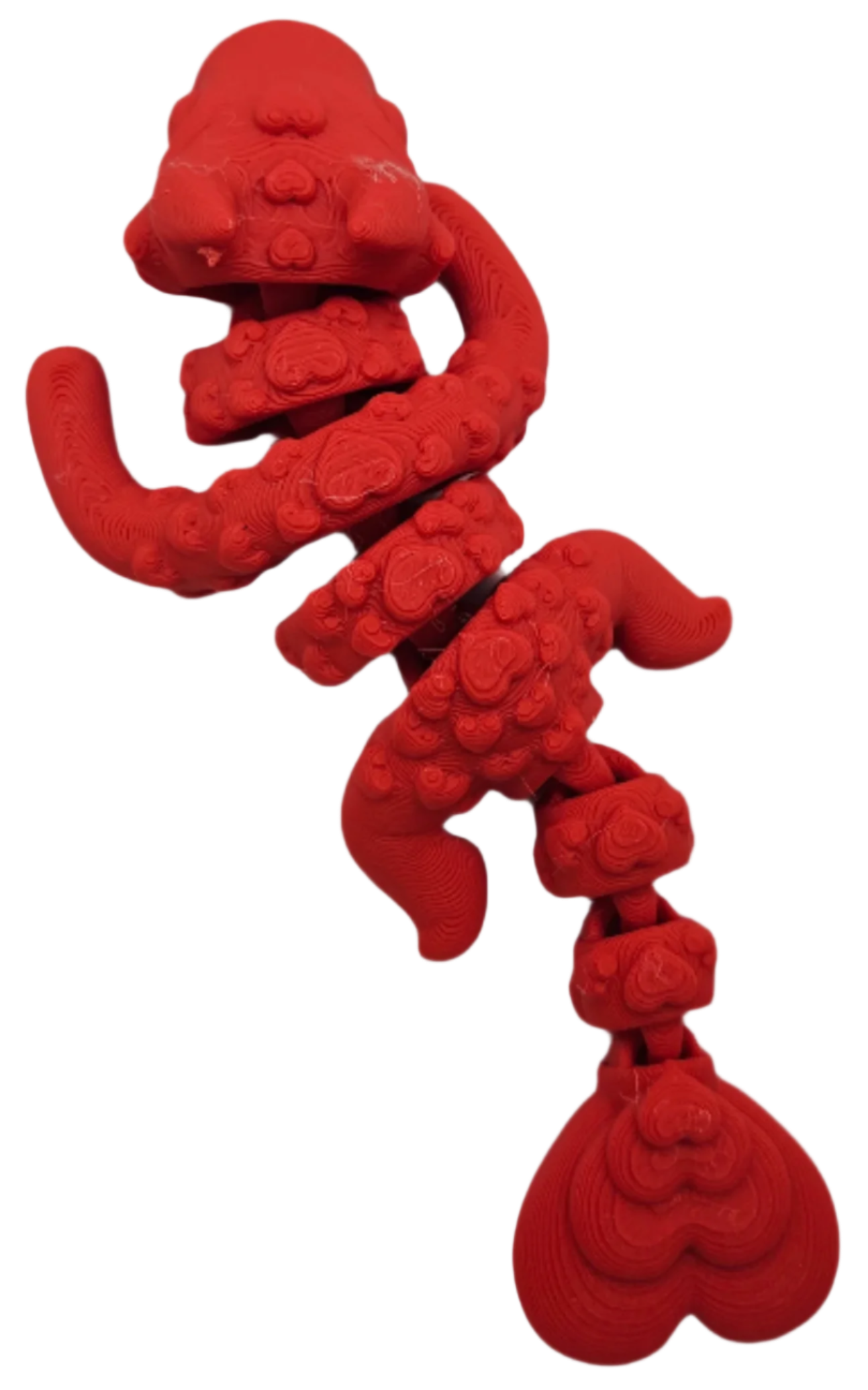 A red, vertically-oriented sculpture, composed of stacked, undulating shapes reminiscent of stylized organs or abstracted hearts, is isolated against a solid black background.