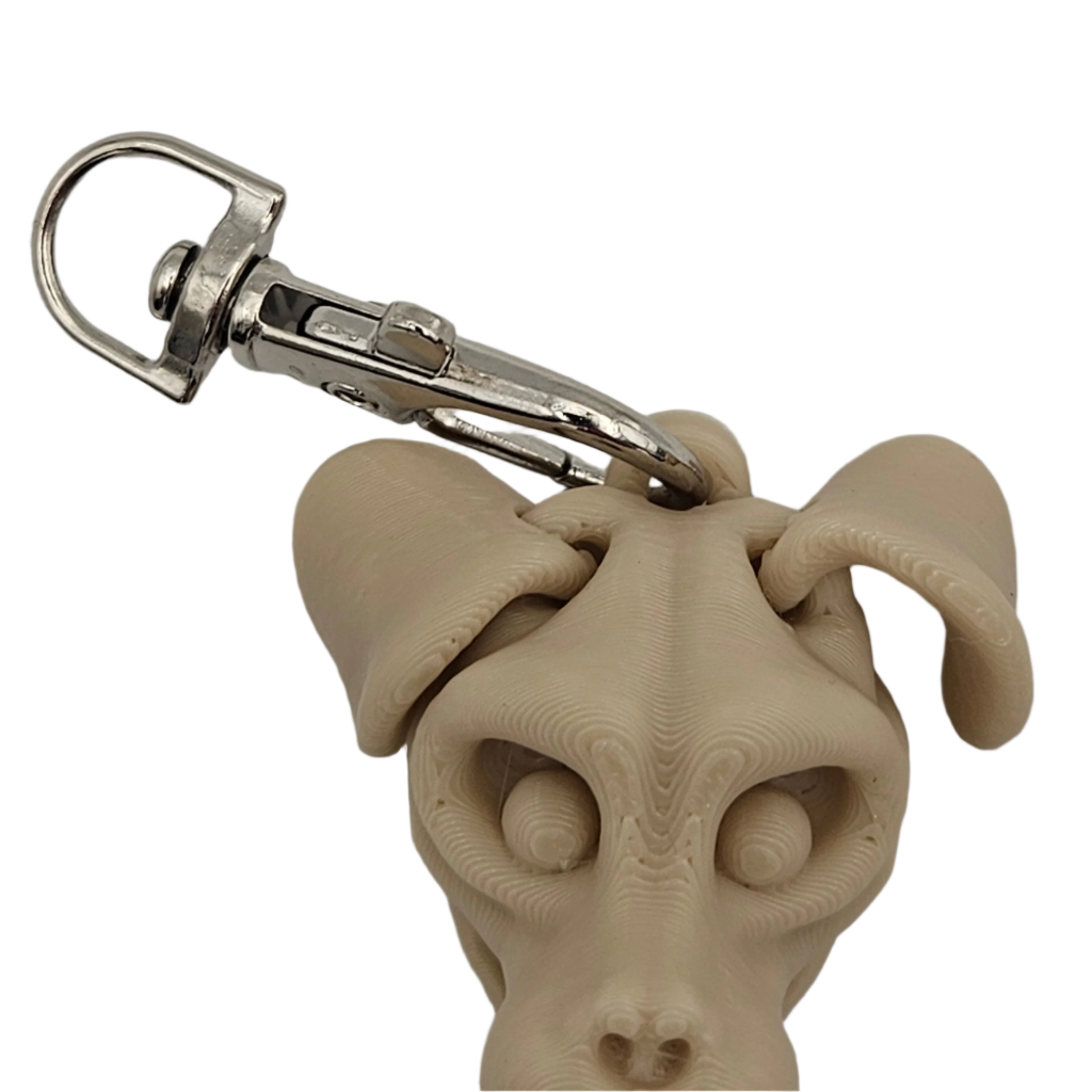 A 3D-printed dog head is attached to a metal clip, which is positioned at the top of the dog's head on a black background.