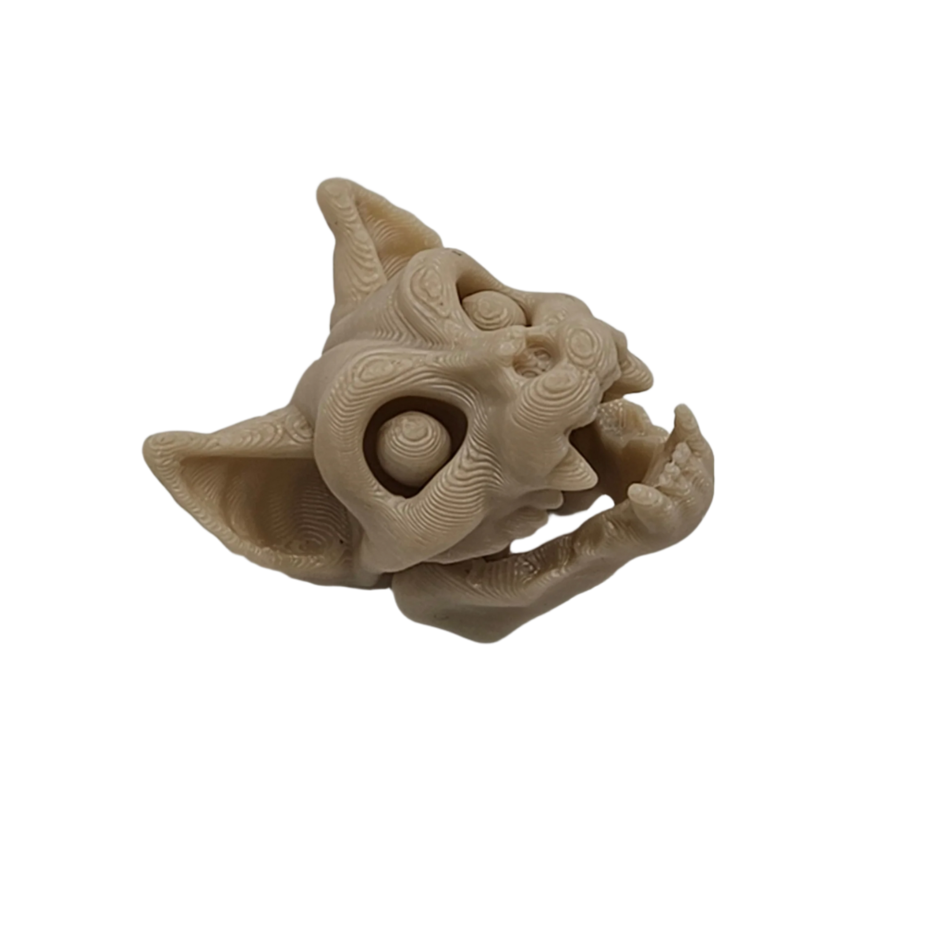 A pale, 3D printed creature head, resembling a cat or gargoyle, appears to be roaring, set against a solid black background.