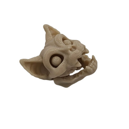 A pale, 3D printed creature head, resembling a cat or gargoyle, appears to be roaring, set against a solid black background.