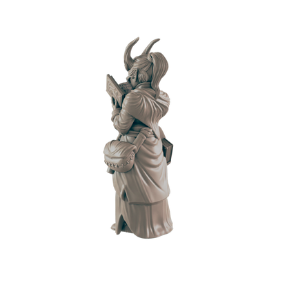 A miniature figurine of a horned woman, reading a book, stands against a dark background.  The text on the book is partially visible.
