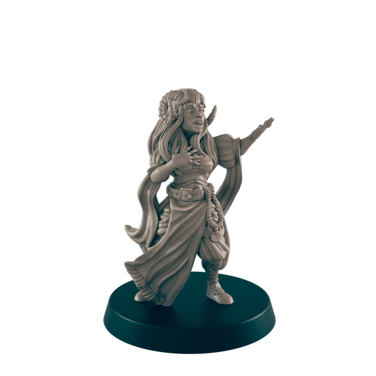 A horned, female figurine is gesturing with one arm outstretched and the other placed on her chest. She stands on a circular base against a black background.