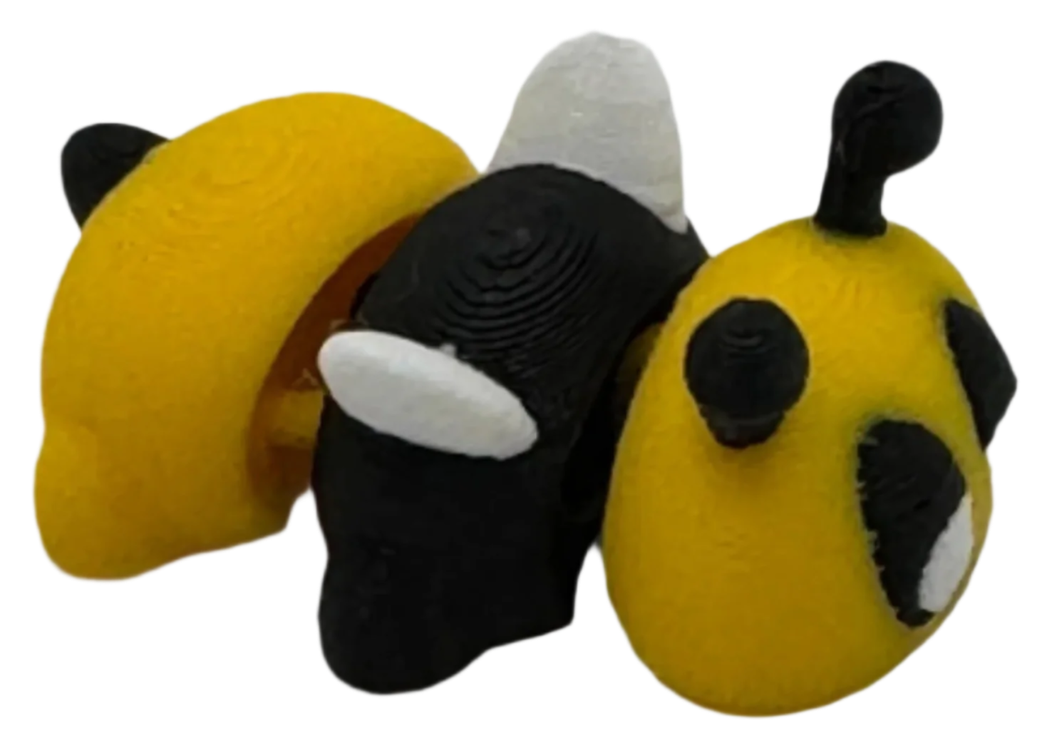 Three small, 3D-printed figures stand together: one half-yellow with black details, one mostly black with white, and one rounded yellow with black spots. They are on a solid black background.