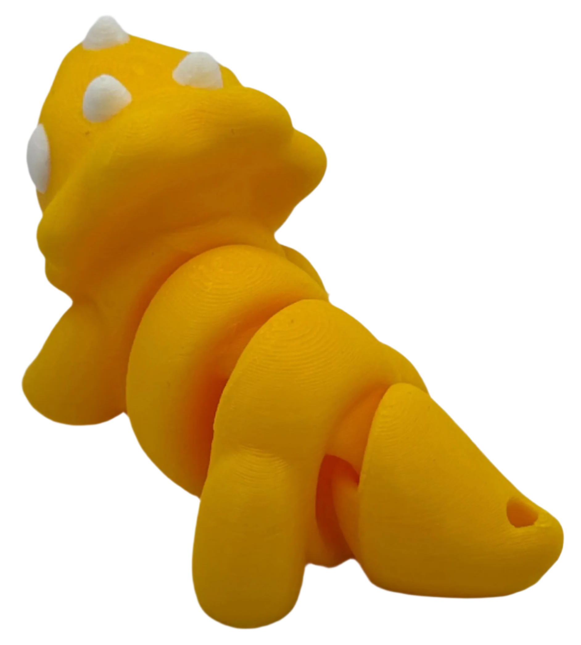 A yellow triceratops-like toy with white spots is displayed, its segmented body arching slightly, against a stark black background.