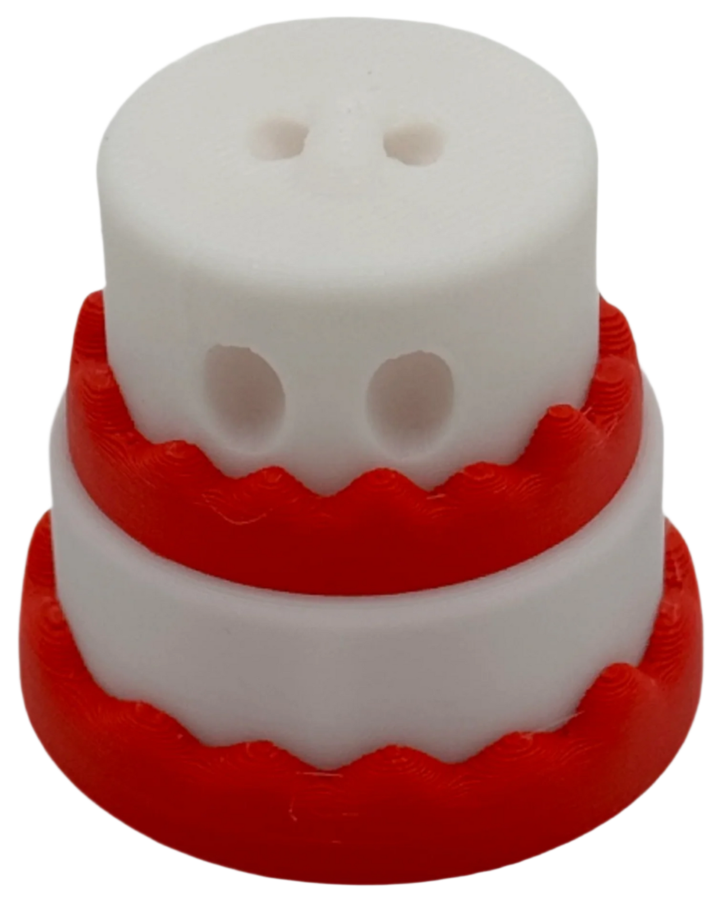 A two-layered cake, white with red frosting, sits on a black background.  The top layer has two small holes.