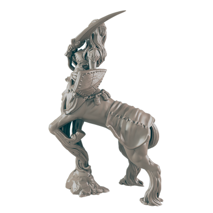 A female centaur figurine stands, wielding a sword and shield;  it is posed dynamically on a rocky base.