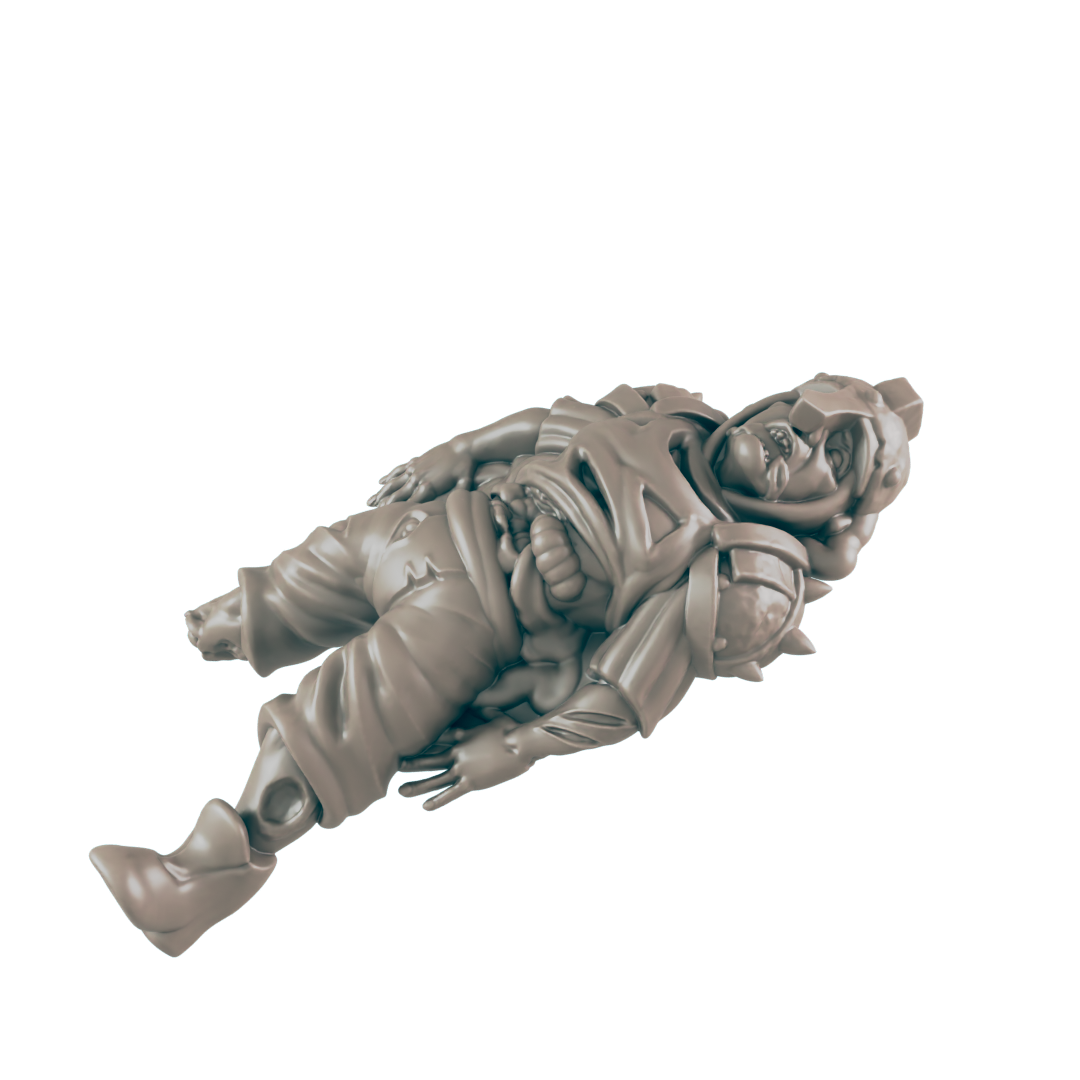 A light greyish-tan, morbid, miniature soldier lies supine on the dark, isolating background. Its stomach appears to be spilling out, and the soldier has shoulder armor.