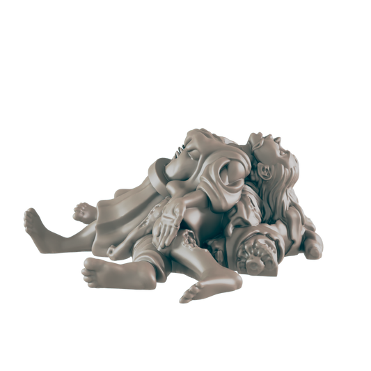 A grayish statue of multiple people is lying in a pile. The people are intertwined and their faces are angled upward.