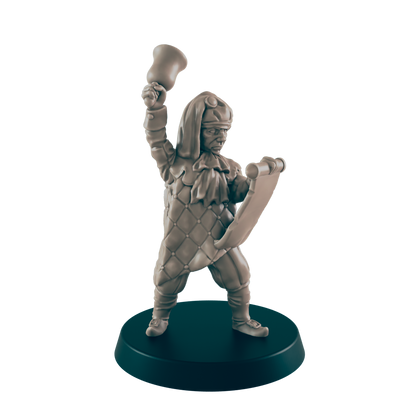 A miniature jester figure raises a bell while holding a scroll; it stands on a circular base against a dark background.