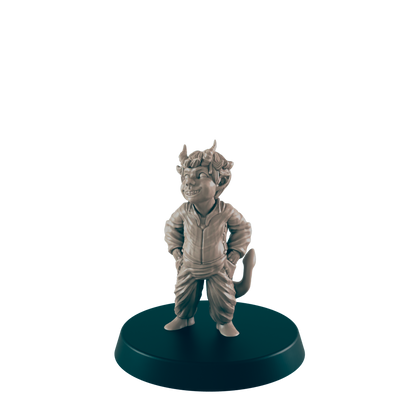 A small, smiling imp figurine stands on a round base against a dark background.  The figurine is sculpted in a relaxed pose, hands in pockets.
