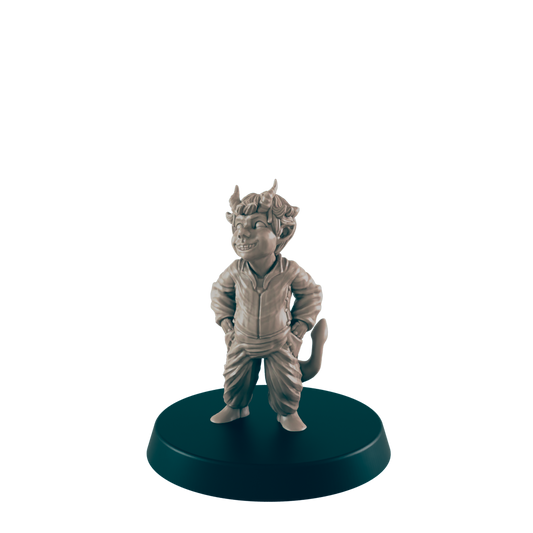 A small, smiling imp figurine stands on a round base against a dark background.  The figurine is sculpted in a relaxed pose, hands in pockets.