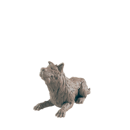 A wolf figurine lies on a dark background, appearing to hold a small object in its mouth.