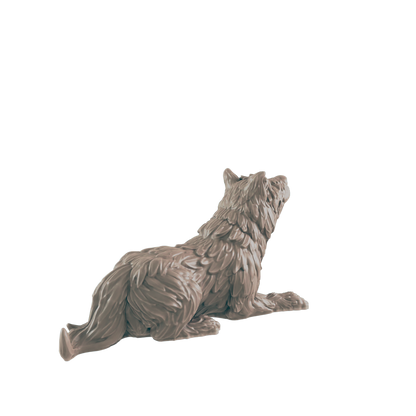 A wolf figurine lies down, looking upward, against a dark background.