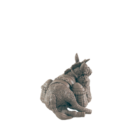 A donkey figurine rests on its haunches, burdened by several sacks, against a dark background.