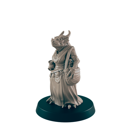 A dragon-like figurine stands, holding a pot and basket.  It wears a robe and is positioned on a dark circular base.